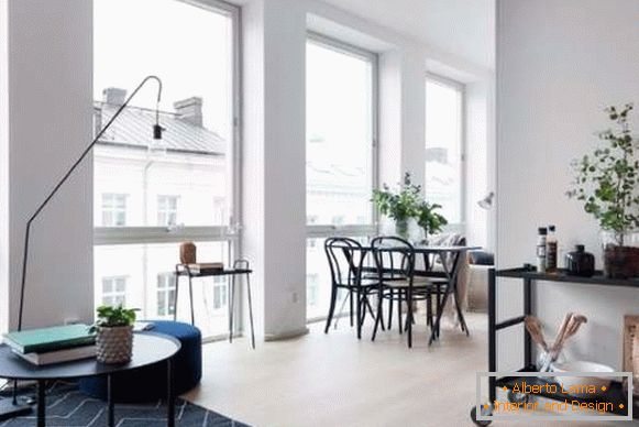 Design of a small studio apartment of 30 sq. M - a photo of a living room and a dining area