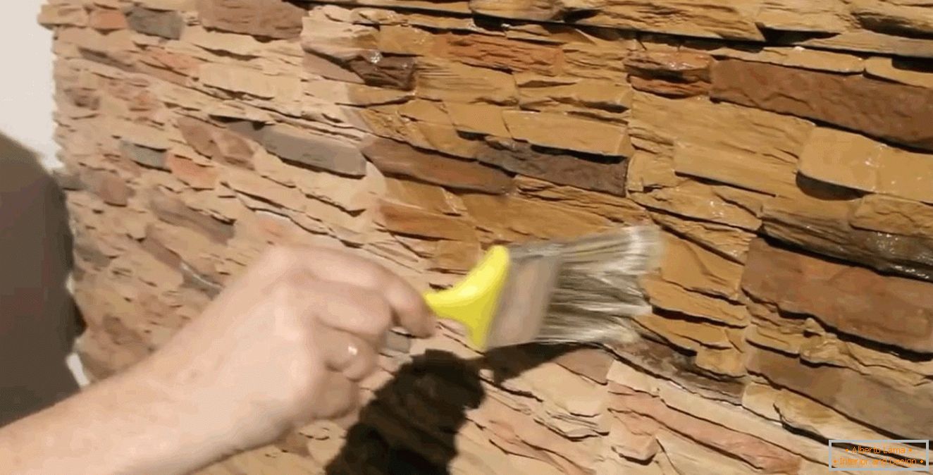 Applying varnish to the tile under the stone