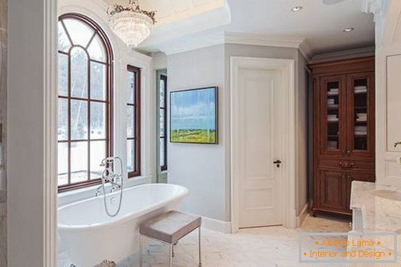 Light doors in the interior of the bathroom with white tiles