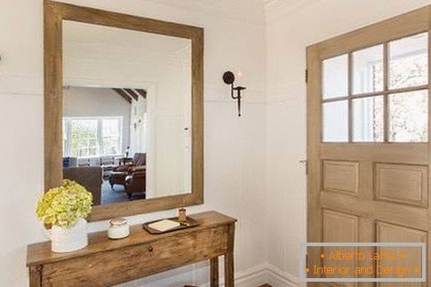 Wooden mirror in the hallway frame