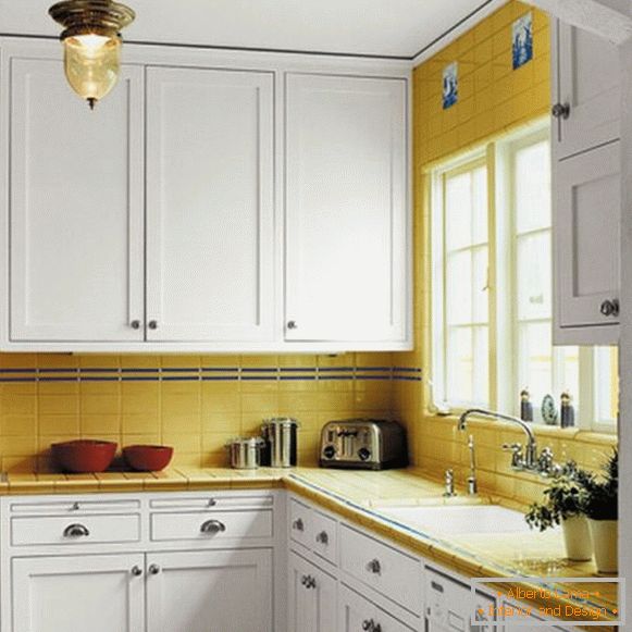 Yellow accents on the white kitchen