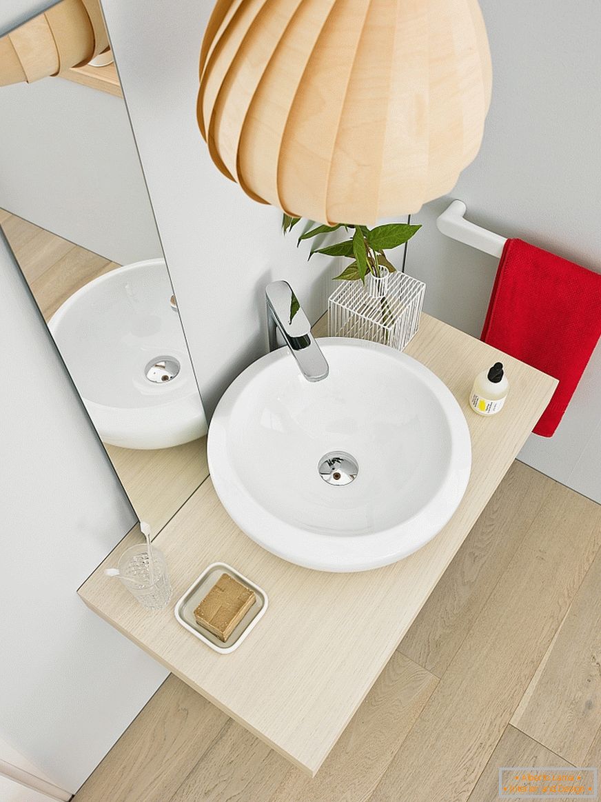 Round washbasin in the interior of a small bathroom