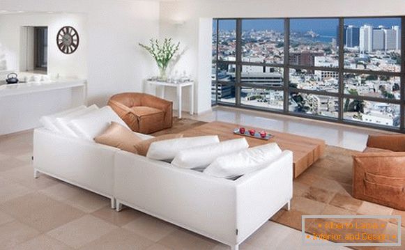 White sofa in front of the panoramic window
