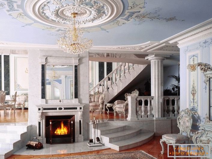 The hall with a fireplace in the neoclassic style is notable for the color scheme chosen for decoration. A gentle blue and white shade harmoniously combined in a single composition.