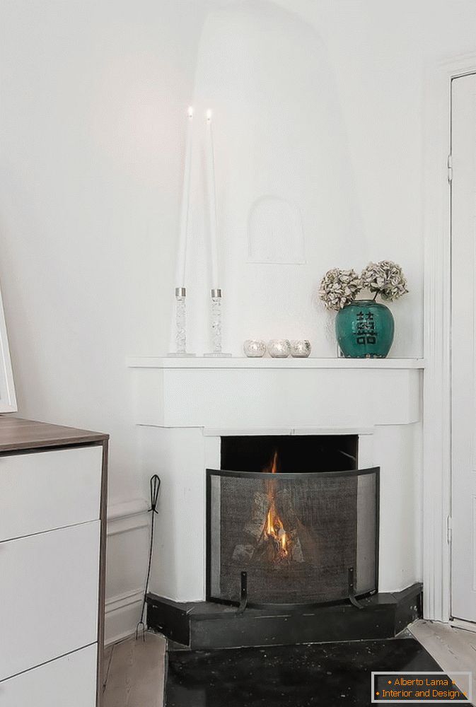 Fireplace in studio apartment in Scandinavian style