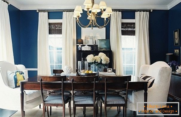 Blue walls in the dining room with low ceilings