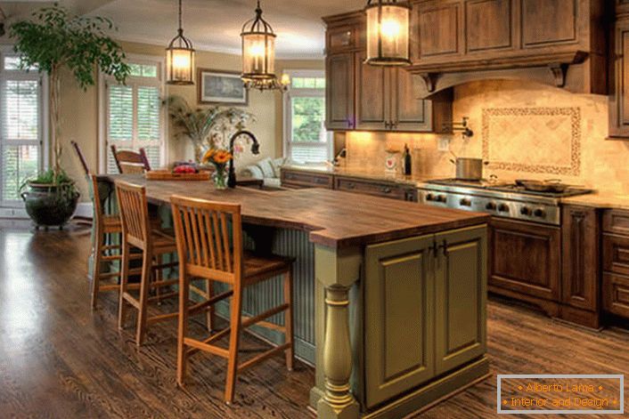 Large kitchen in country style with massive wooden furniture. Excellent combination of colors - olive and dark brown.