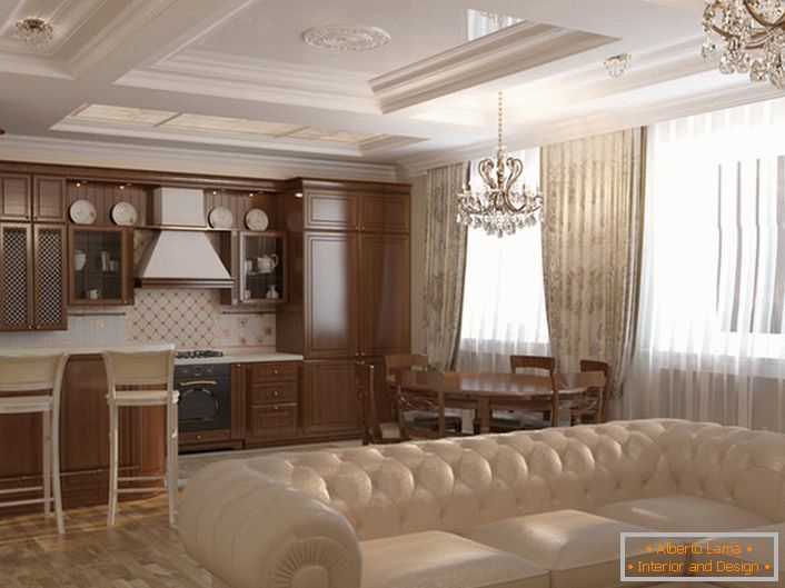 Kitchen-living room is decorated in Art Nouveau style. Light colors, furniture from natural wood, massive ceiling chandeliers made of crystal are matched in accordance with the style.