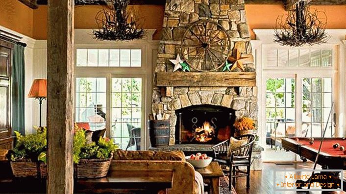 The fireplace made of natural stone is an indispensable attribute in the interior in a rustic style.