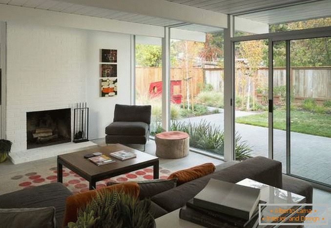 Design of a living room with a panoramic window - a photo in the interior of a private house