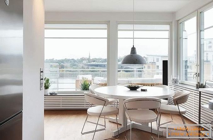 Kitchen design with panoramic windows in a corner apartment