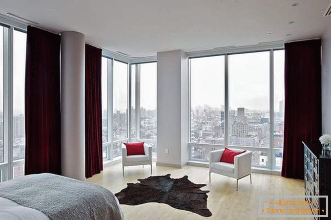 Panoramic windows - photo in the interior of a bedroom in a corner apartment