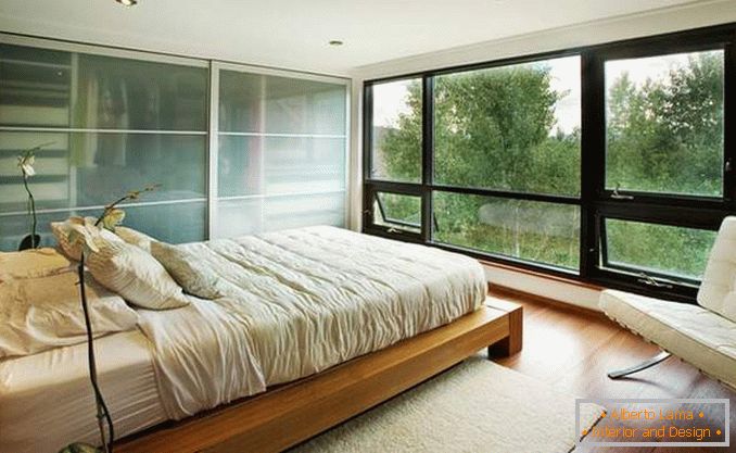 Bedroom with panoramic windows - photo in the interior of the house