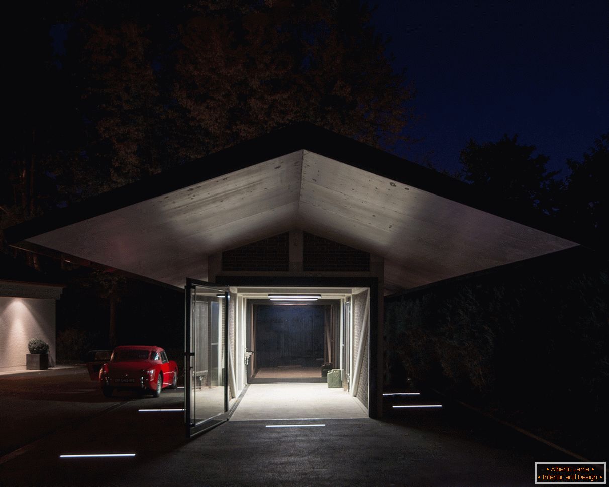 Evening illumination of the garage with a canopy