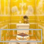 Yellow tile with white ornament in the toilet