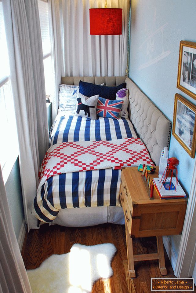 A bedside table near the bed in a small bedroom