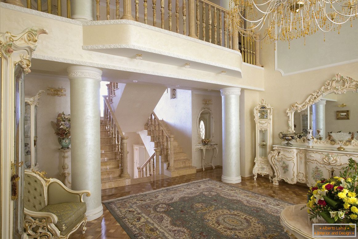 The baroque style living room is notable for the columns with a small acting balcony on the second floor.