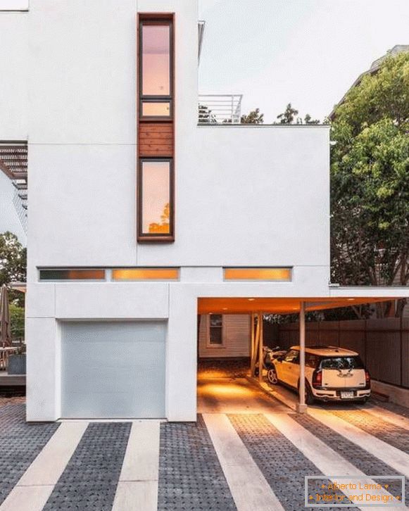 House in the style of minimalism with a carport for cars