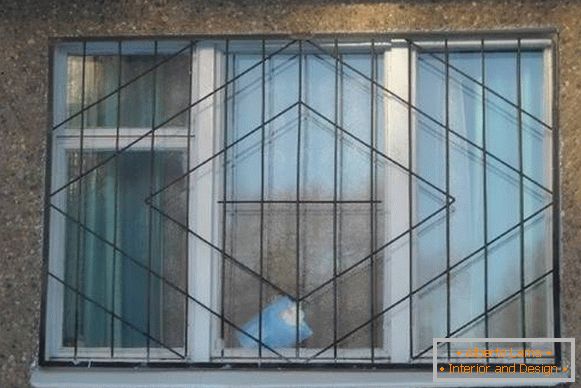 Welded metal grilles on windows - photo from the facade