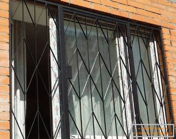 Metal swinging grilles on the windows of the ground floor