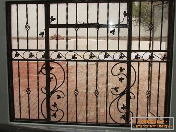 Beautiful forged grilles on the windows - photo of the house