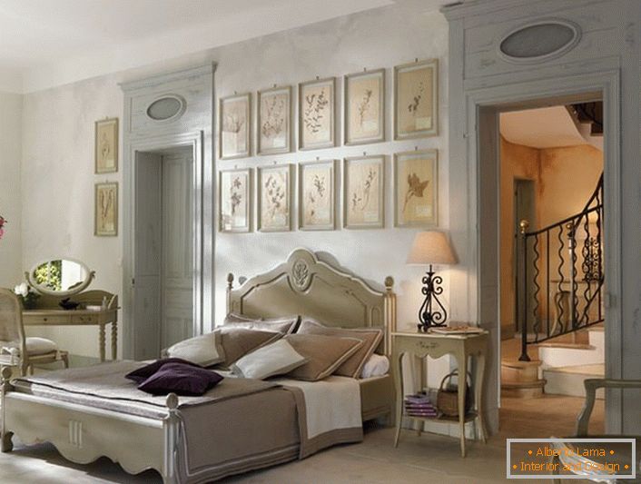 In accordance with the traditions of the French style for the bedroom was selected laconic light furniture of wood. An interesting detail is a collage of pictures above the head of the bed.