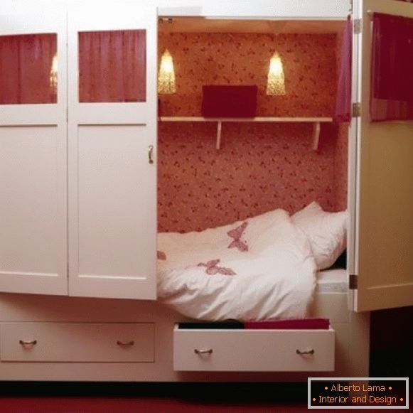 Cozy baby bed in a former cupboard