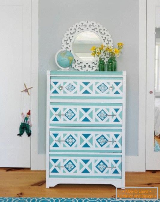 White chest of drawers with patterns on drawers
