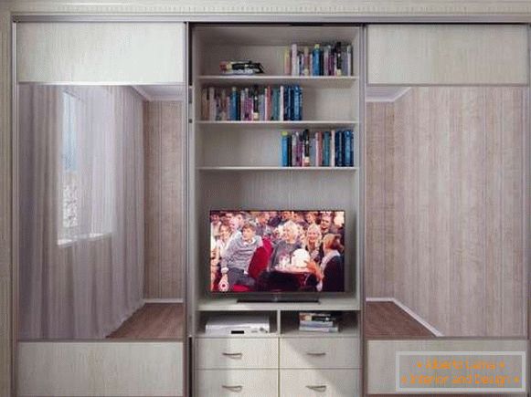 Closet of a compartment with a curbstone under the TV in a bedroom - a photo of samples