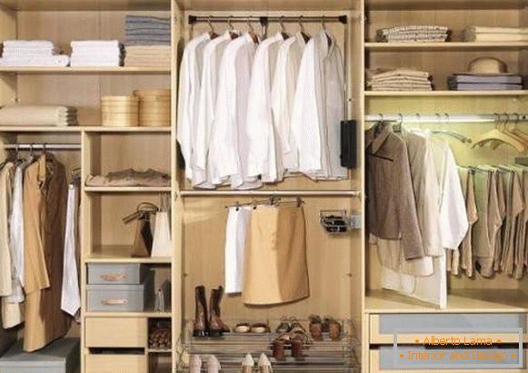 Three-winged wardrobe compartment in the bedroom - interior filling in the photo