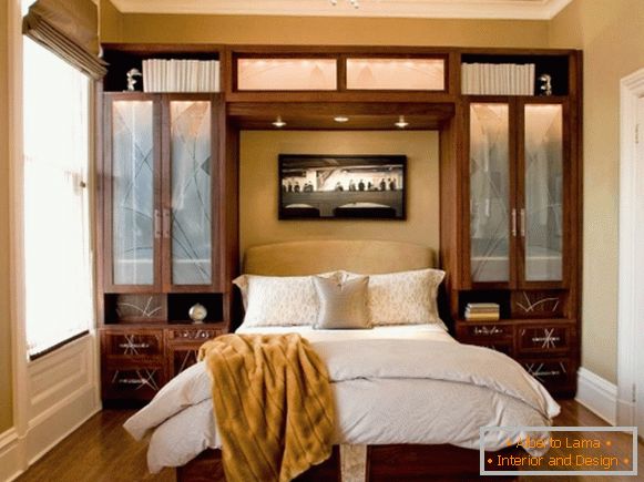 Built-in wardrobes in the bedroom on the sides of the bed