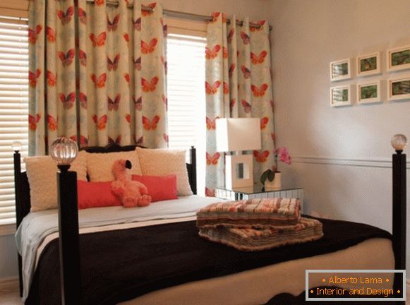White curtains on the eyelets in the bedroom with an orange pattern