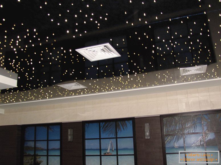 The glossy stretch ceiling of PVC imitates the night sky, the starry sky. Great idea for a bedroom or a children's room.