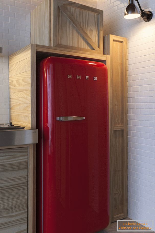 Red refrigerator in the interior design of a small apartment