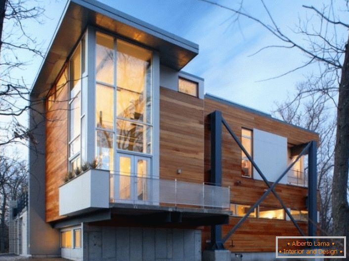 The wooden walls of the house are in high-tech style with stylish plastic panoramic windows.