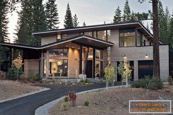 Exterior finishing of a modern private house with wood siding