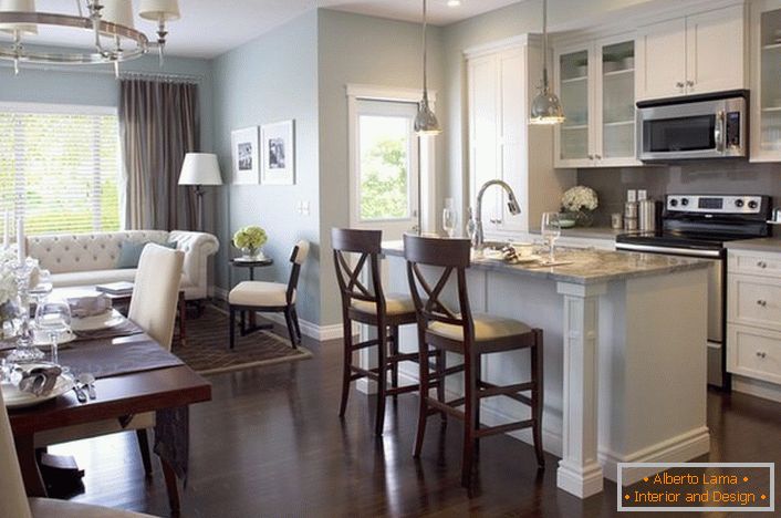 Chosen in the style of the recreation area, kitchen furniture does not spoil the general mood of a spacious living room.