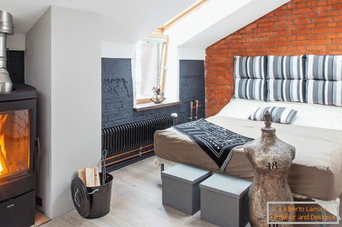 Bedroom with a small fireplace in the loft style