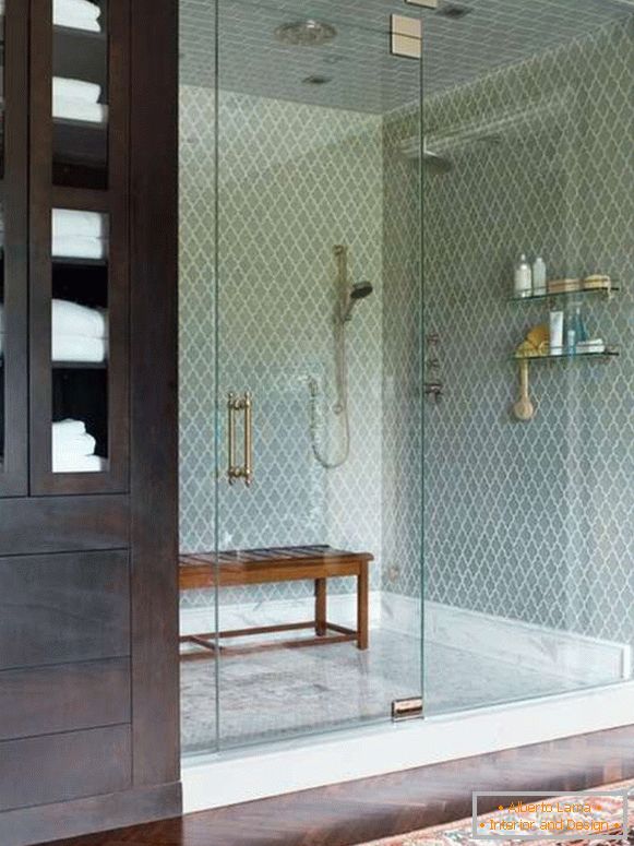 A beautiful glass door for a shower in a niche with a fence
