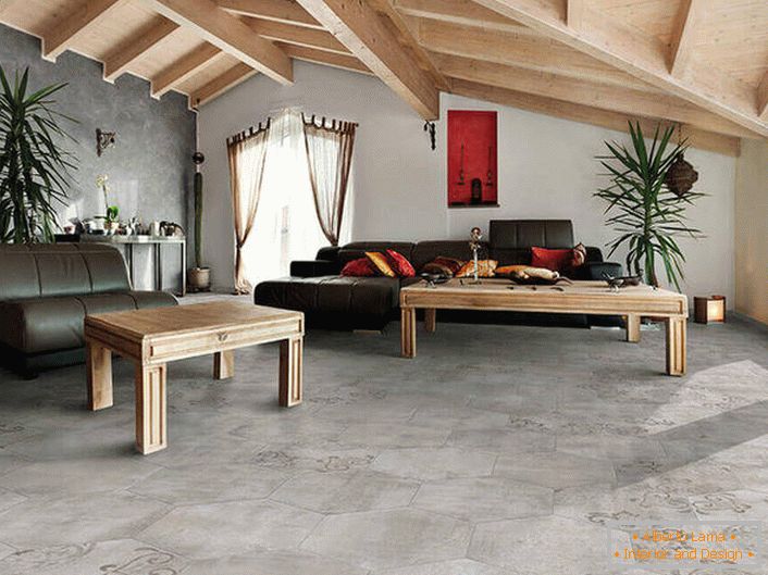 The covering of floors and walls imitates a rough finish. The ceilings of wood are combined into a common composition with furniture. A lucky variation of the loft style in the living room.