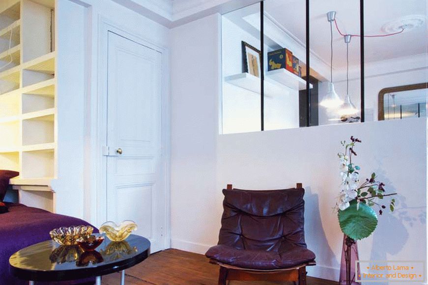 Glass partition in the living room of a small studio apartment in Paris