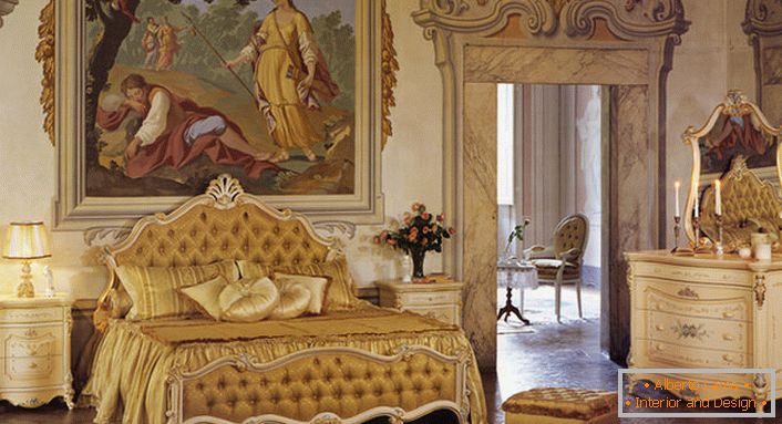 Bedroom in Baroque style in golden colors. The wall at the head of the bed is decorated with a huge ancient painting.