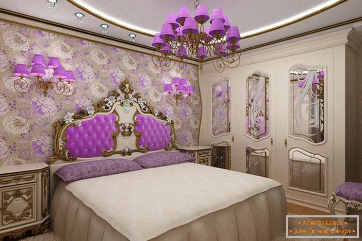 Elegant baroque bedroom with an interesting accent on lighting. Chandelier and bedside lamps with the same violet shades harmoniously combined with the backrest upholstery at the head of the bed.