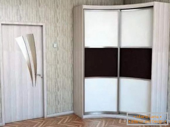 Corner wardrobe compartment in the bedroom with two radius doors