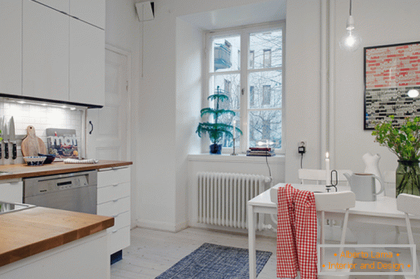 Kitchen with dining area of ​​a small apartment in Scandinavian style