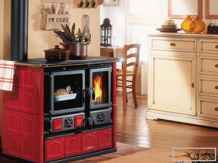 The fireplace in red and black colors is a decoration of the kitchen in the style of Provence.