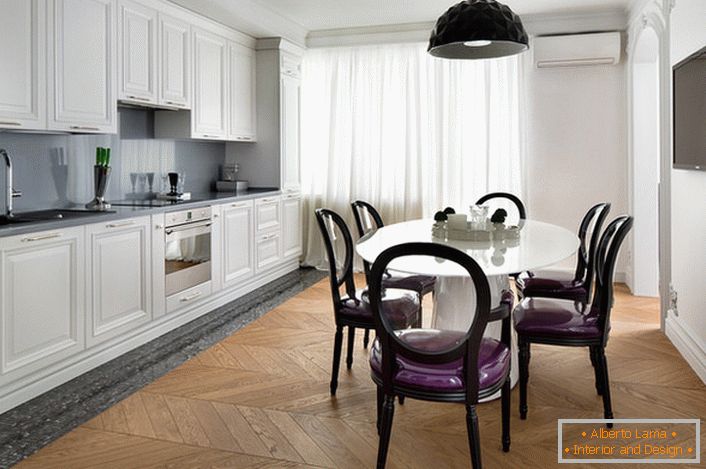 White interior kitchen with accents of dark gray in eclectic style. Interesting chairs with transparent backs and purple soft upholstery.