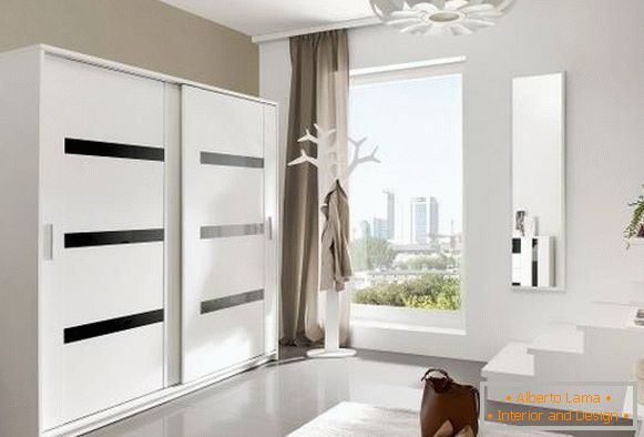 Modern design of the wardrobes in the hallway in white color
