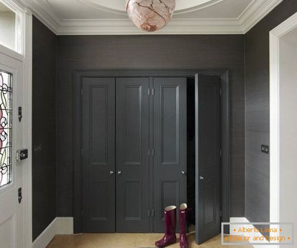 Built-in wardrobe in black color in the hallway of a private house