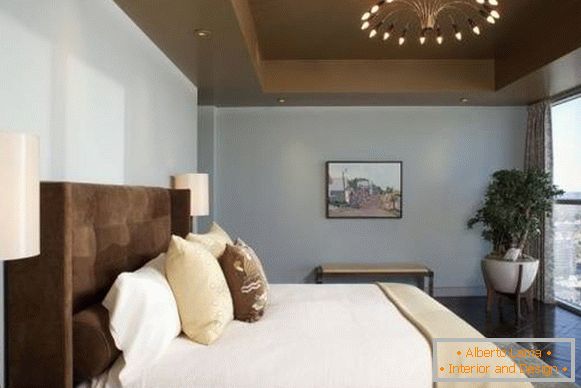 Bedroom with blue walls and brown details